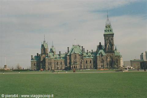 Ottawa Parliament buildings with green copper roofs under cloudy sky
