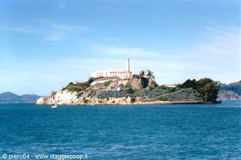 Alcatraz Island with the former prison and lighthouse, blue bay waters