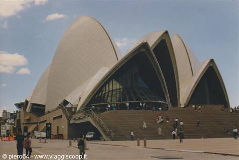 Tourists climb the grand steps of Sydney Opera House under sunny sky