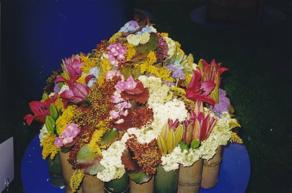 Flower arrangement with pink lilies and white blooms in bamboo vases