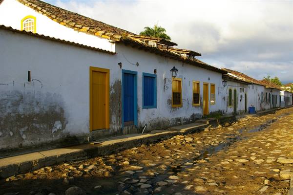 White colonial houses with colorful doors along Paraty cobblestone street