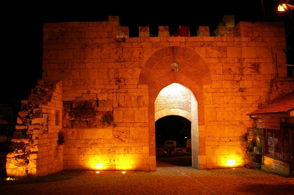 Ancient stone city gate lit at night, Hadrian's Gate, Side