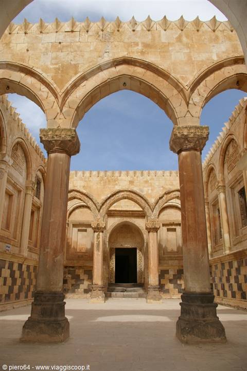 Courtyard of Ishak Pasha Palace, golden stone arches and carved columns