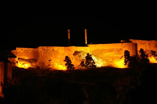 Ankara Citadel walls lit at night, ancient stone ramparts glowing golden
