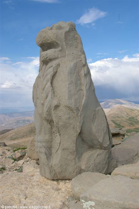 Stone lion statue on the Nemrut Dagi mound amid arid mountains