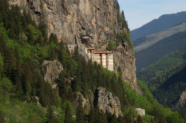 Sumela Monastery clinging to the rocky cliff, surrounded by green forests