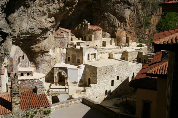 Sumela Monastery carved into the cliff, stone buildings and red-tiled roofs