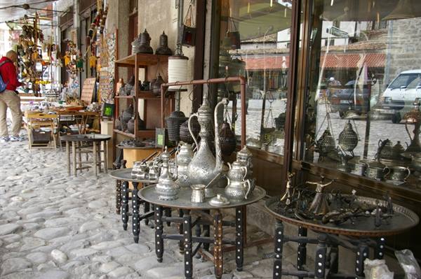 Copper teapots displayed outside a shop on cobblestone street, Safranbolu