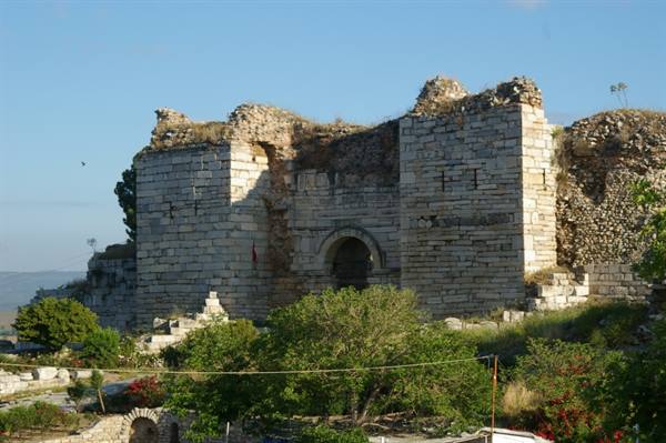 Ancient stone walls with central arch at Miletus, morning light