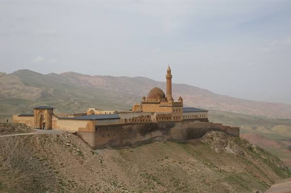 Ishak Pasha Palace near Doğubayazıt, golden stone, dome and minaret among arid hills