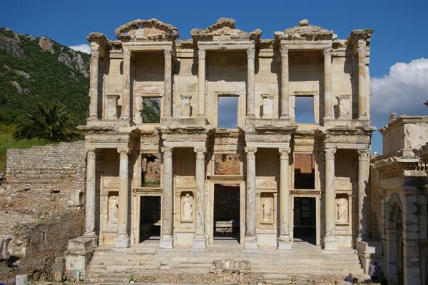 Marble facade of the Library of Celsus at Ephesus, columns and statues under blue sky