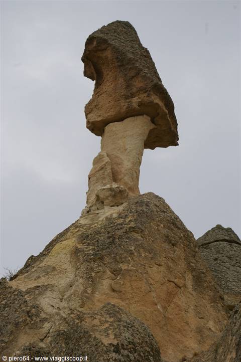 Fairy chimney in Cappadocia, mushroom-shaped tuff rock under grey sky