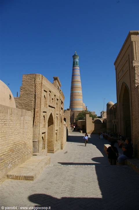 Islam Khoja minaret towers above the brick alley of Khiva