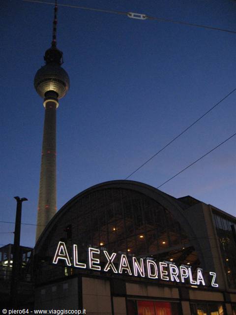 Illuminated Alexanderplatz sign and TV Tower at dusk in Berlin
