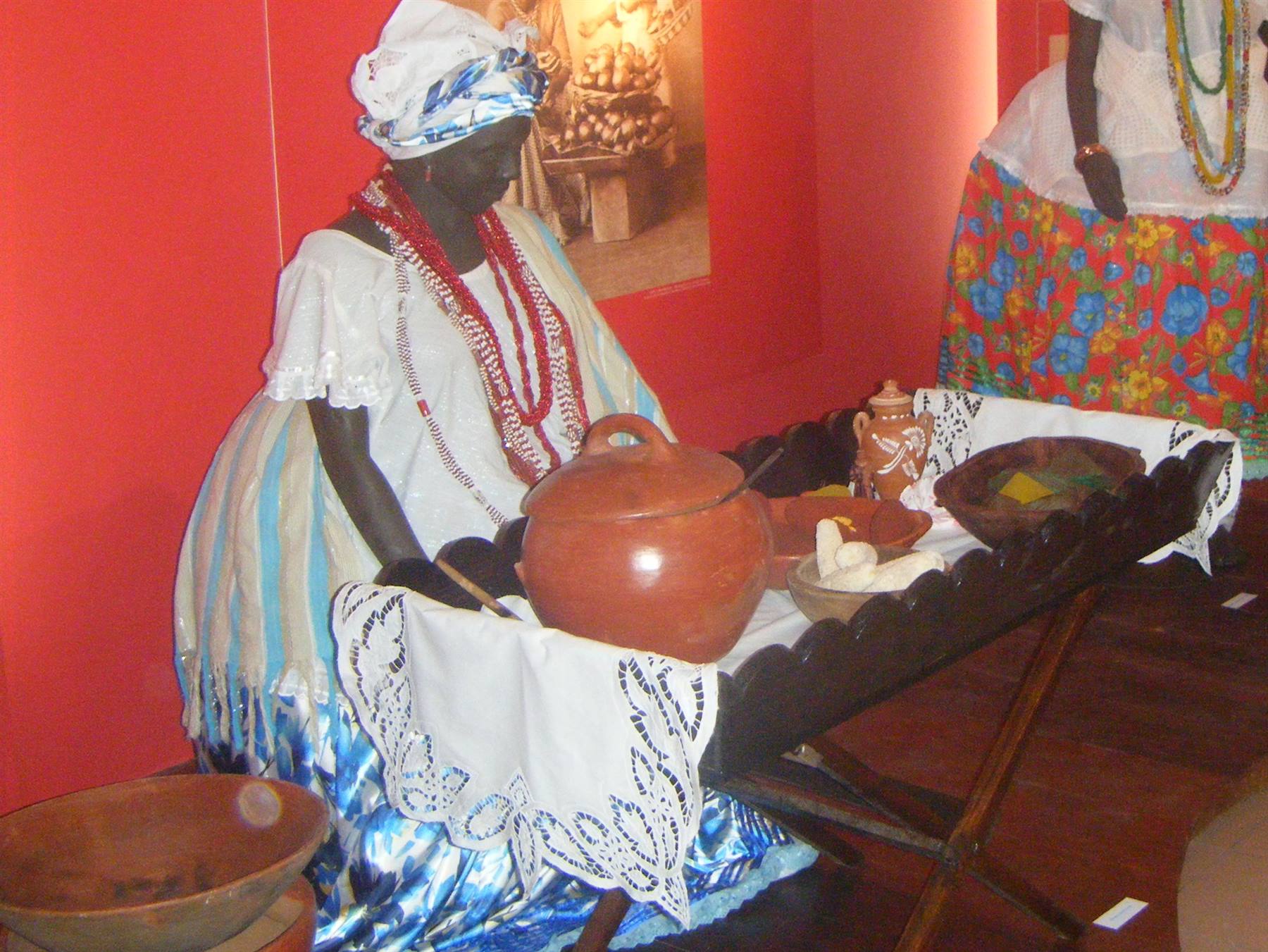 Baiana woman statue in white and blue dress with clay pottery