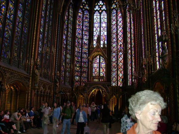 Sainte-Chapelle in Paris, visitors beneath colorful Gothic stained glass windows