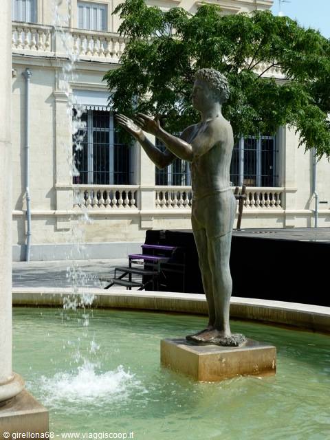 Bronze statue of a boy catching water in the Aix-en-Provence fountain