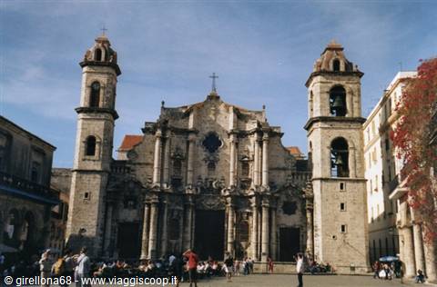 People strolling in front of Havana Cathedral's weathered baroque stone facade and twin towers