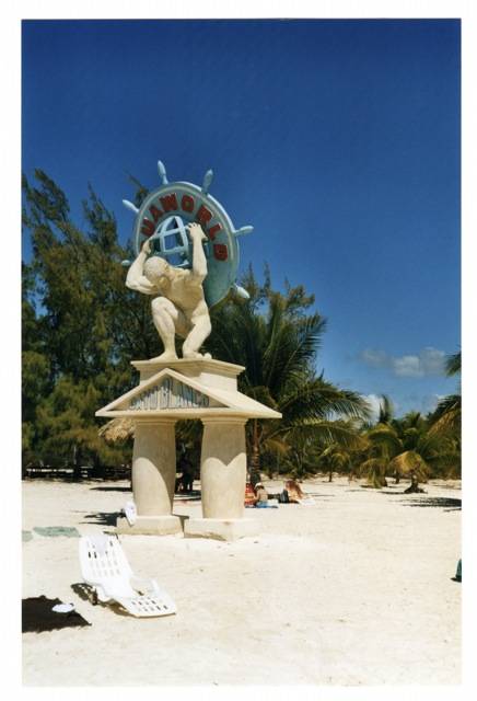 Atlas statue holding a globe on the CocoWorld beach