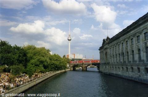 The Spree in Berlin with the Fernsehturm and a red train on the bridge