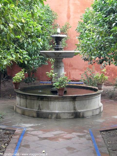 Marble fountain among orange trees in the courtyard of Seville's Alcázar