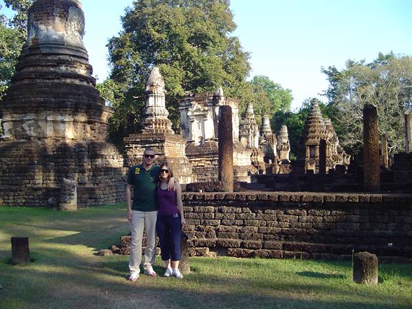 Couple among brick and laterite chedis at Sukhothai Historical Park
