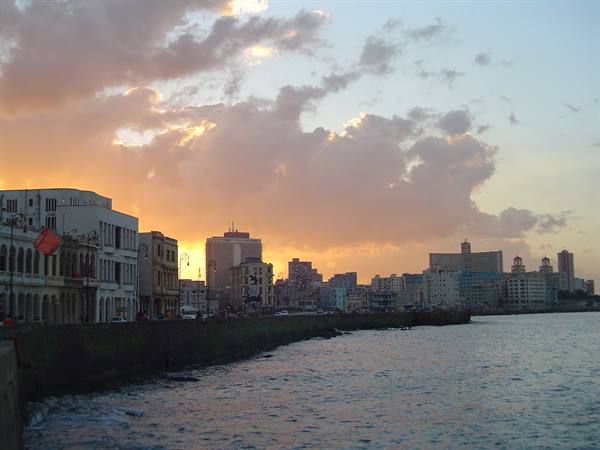 Havana's Malecón at dusk, colonial buildings and towers by the sea