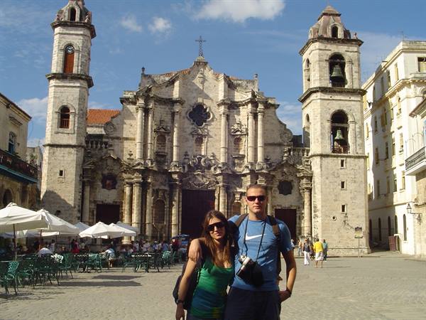 Tourist couple in front of Havana Cathedral in Plaza de la Catedral