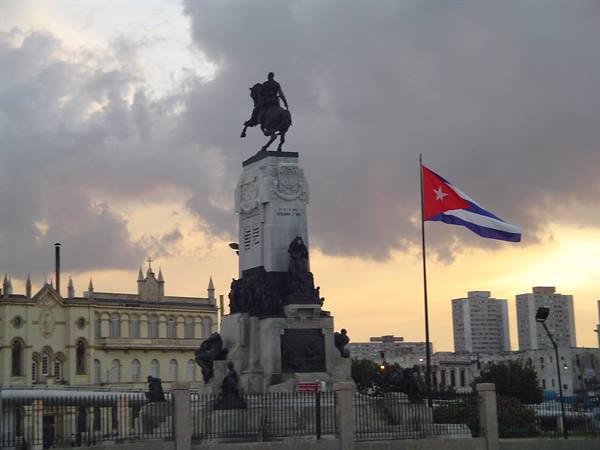 Antonio Maceo equestrian monument in Havana, Cuban flag waving among clouds
