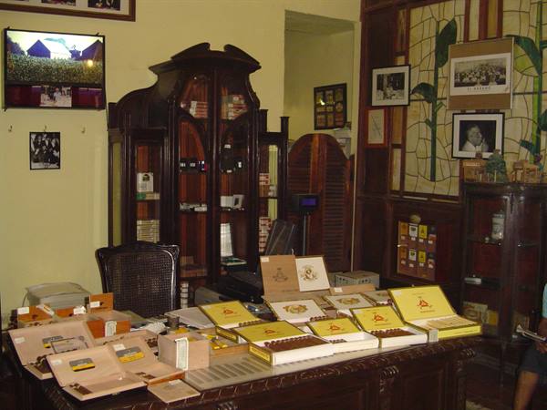 Montecristo cigar boxes displayed on a wooden counter inside a shop