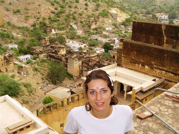Tourist with bindi on Galtaji terrace, Jaipur, among temples and arid hills