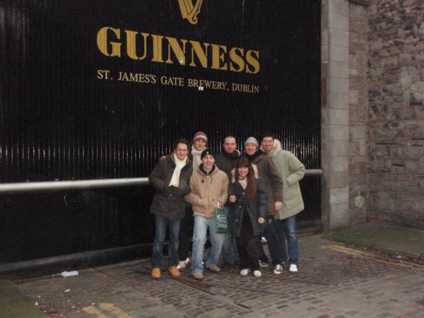 Group of friends in coats outside the Guinness gate, St. James's Gate, Dublin