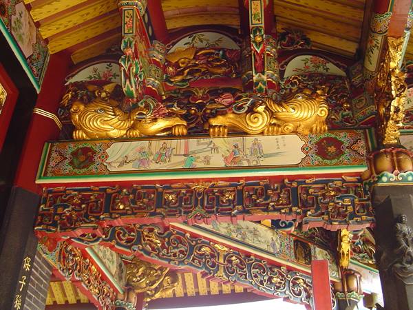 Gilded carved lions and painted beams inside a temple