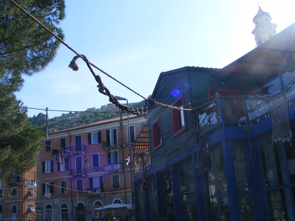 rope stretched between pines and blue wooden shack, colored houses on the hill