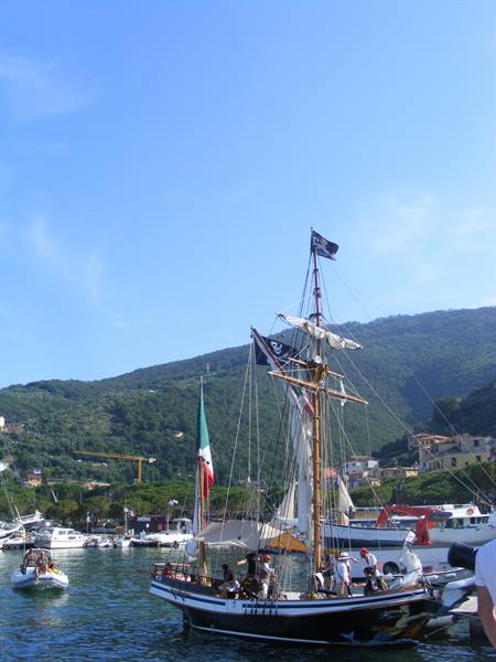 Sailing ship with pirate flag moored in Santa Margherita Ligure harbour