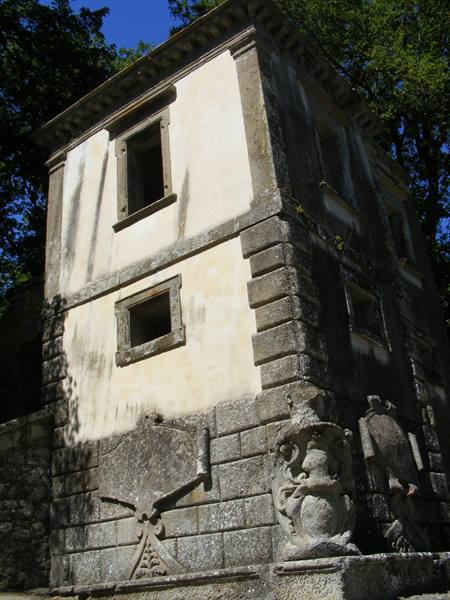 Leaning House in Bomarzo's Sacred Grove, plastered walls and stone sculptures