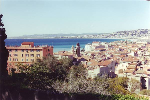 Red rooftops of old Nice facing the blue Mediterranean, bright daylight