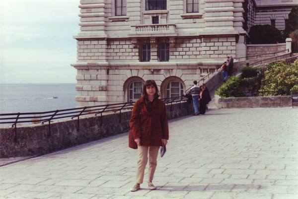 Girl in red coat in front of the Oceanographic Museum in Monaco