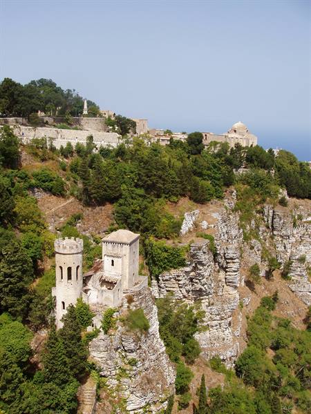 Medieval stone tower on Erice cliff, sea in the background