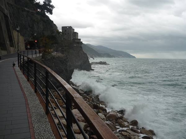 Waves crash on rocks along the seaside promenade of Monterosso al Mare