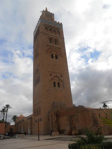 The Koutoubia minaret in Marrakech, red brick against cloudy sky