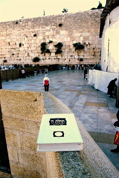 Jewish prayer book resting on a stone ledge before the Western Wall