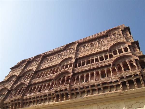Pink sandstone facade with carved balconies and arches, Mehrangarh Fort, Jodhpur