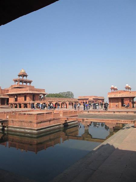 Fatehpur Sikri: red sandstone Panch Mahal pavilion reflected in the pool