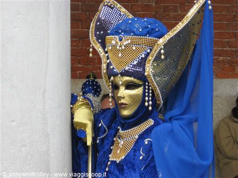 Golden mask with blue headdress and pearls at Venice Carnival