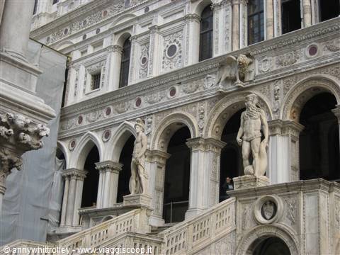 Doge's Palace courtyard in Venice, marble statues and winged lion among white arches
