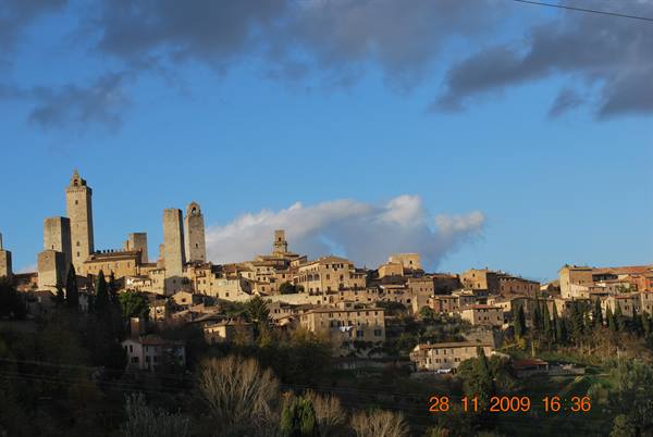 Medieval towers of San Gimignano shine in sunlight among stone houses