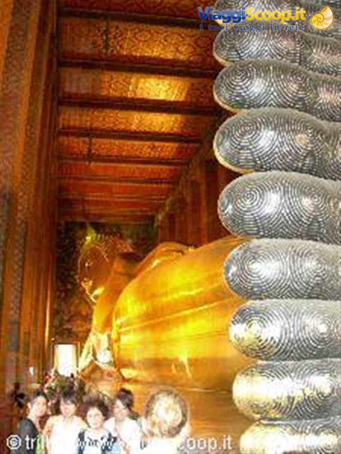 Tourists before the golden Reclining Buddha, feet inlaid with mother-of-pearl, Wat Pho