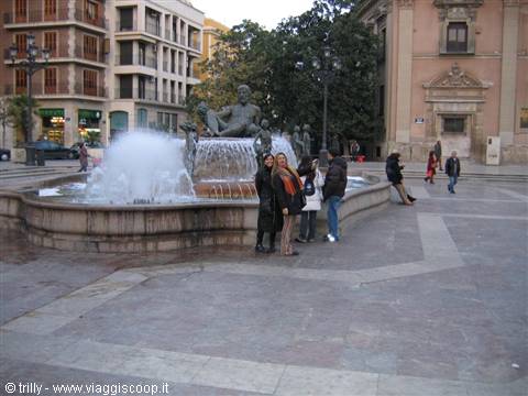 Tourists by the Turia fountain at Plaza de la Virgen, Valencia