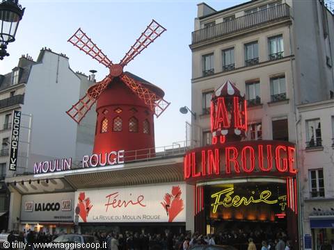 The Moulin Rouge in Paris with its red windmill and neon sign lit